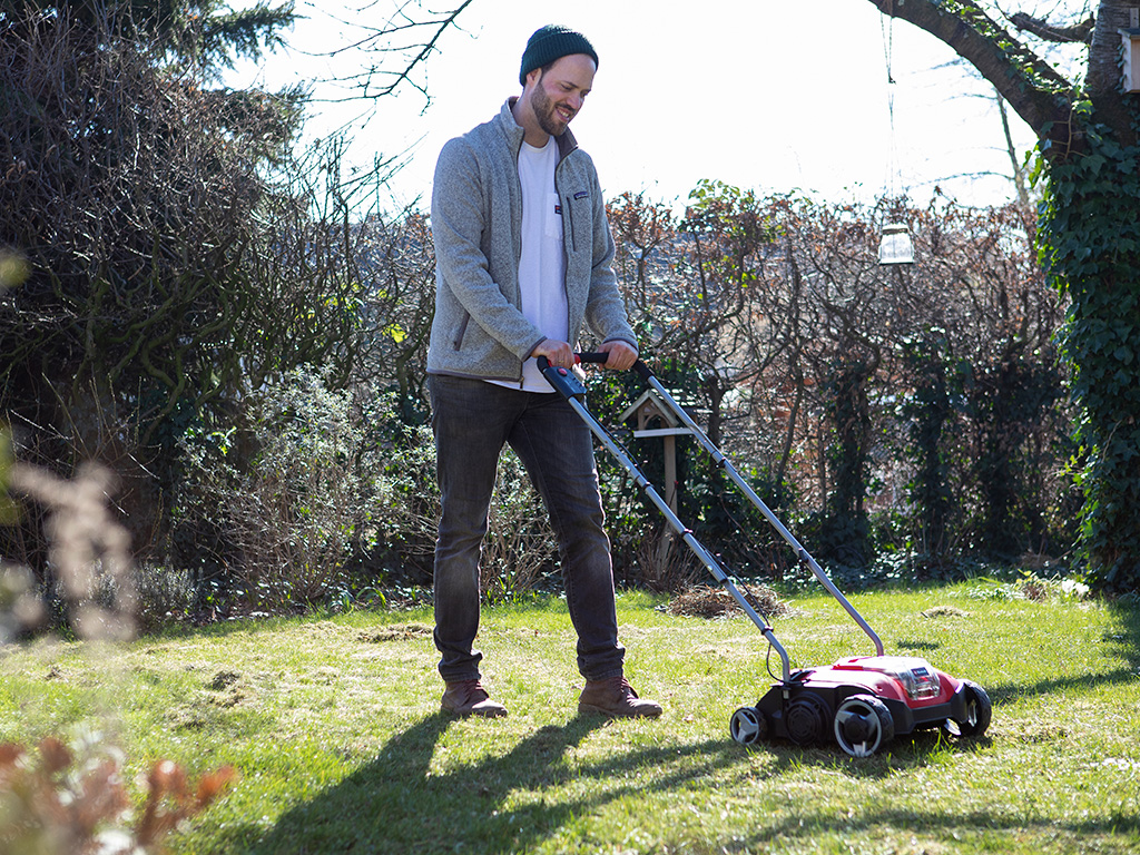 a man mows his lawn