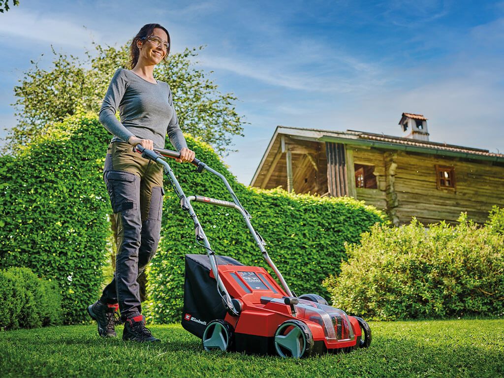A woman working with a battery-powered Einhell scarifier.