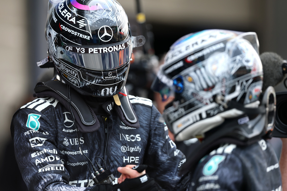 Dvaja jazdci Mercedes F1 v pretekárskych kombinézach a prilbách